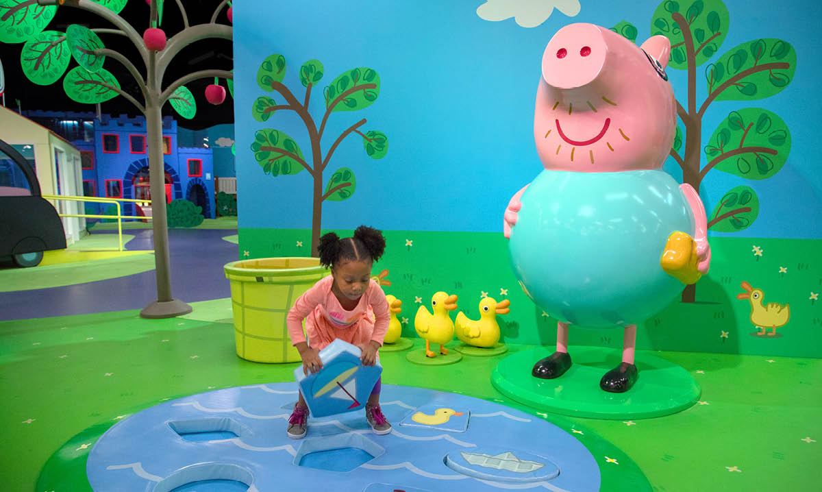 A young child playing at Peppa Pig World of Play in Schaumburg, Illinois, an interactive indoor play place featuring themed activities, colorful play areas, and character experiences for toddlers and preschoolers.
