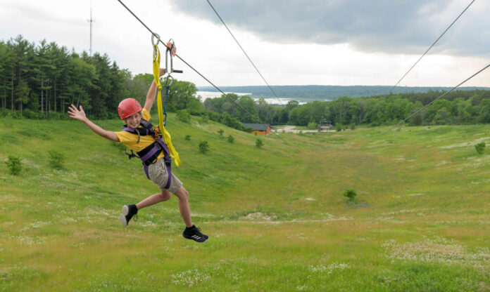Girl zip lining as part of summer in walworth county