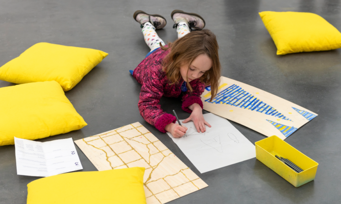 A child draws at Family Day at The Museum of Contemporary Art