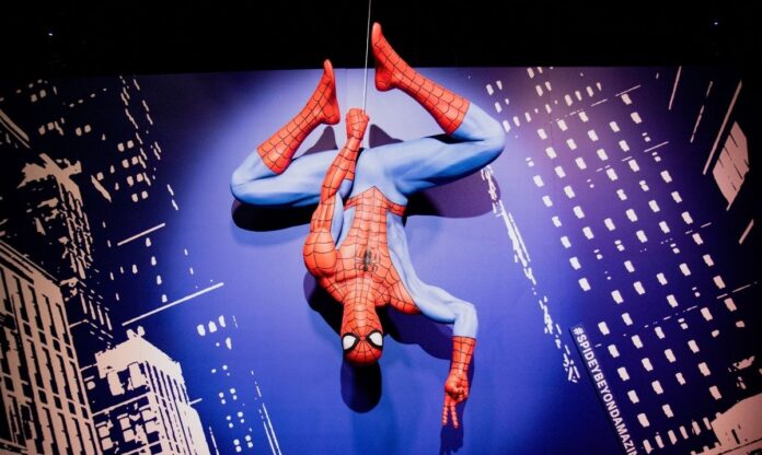 Life-size Spider-Man statue hanging upside down at Marvel's Spider-Man: Beyond Amazing – The Exhibition at MSI Chicago