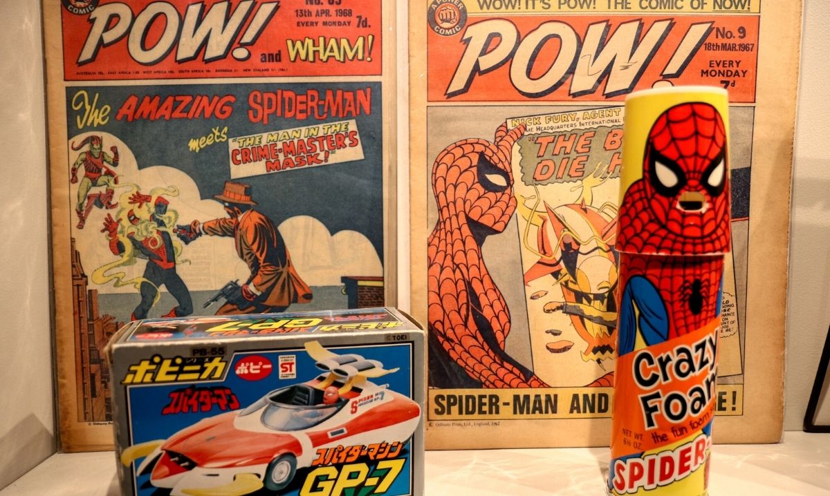 Vintage Spider-Man comics and retro merchandise on display at Marvel's Spider-Man: Beyond Amazing – The Exhibition at MSI Chicago.